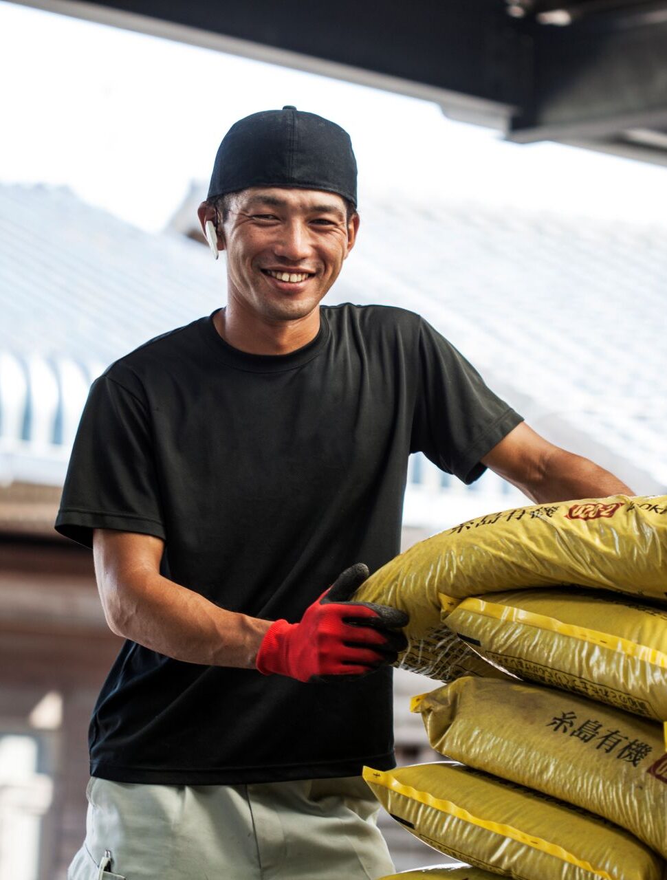 japanese-farmer-wearing-black-cap-standing-next-to-2023-11-27-04-57-35-utc.jpg